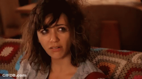 Woman With Messy Hair Sitting On Couch With Blanket GIF