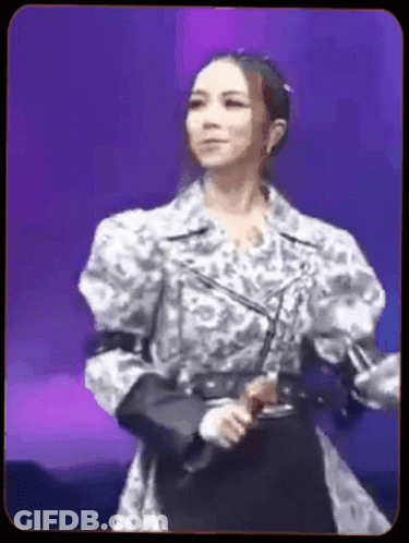 Woman With Microphone On Purple Stage GIF