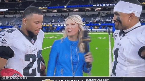 Woman With Microphone Talking To Football Players Number 20 GIF