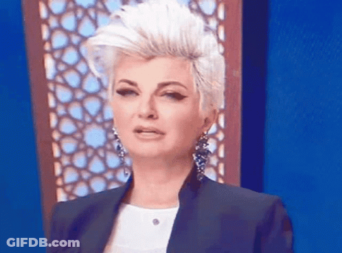 Woman With Mohawk And Earrings Making Funny Face GIF