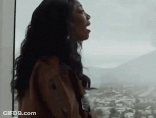 Woman With Mouth Open Looking Out Window GIF