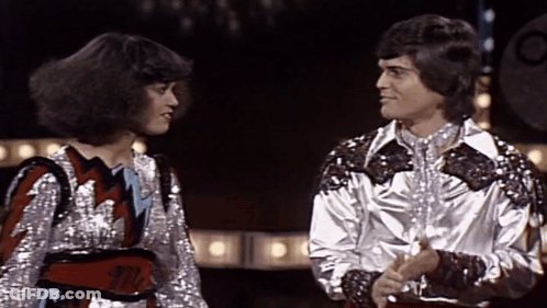 Woman With Mr. Belt Beside Man GIF