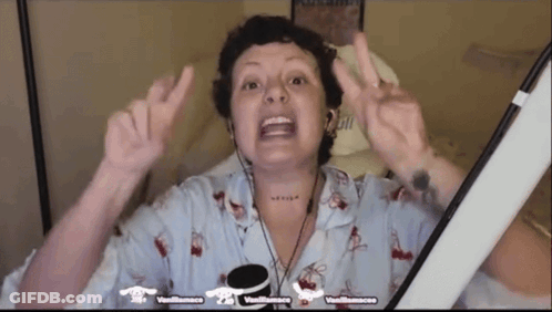Woman With Neck Tattoo Giving Peace Sign Wearing Headphones GIF