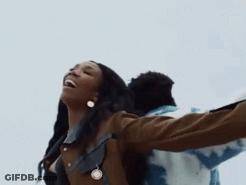 Woman With Necklace And Earrings Beside Man In Blue Jacket GIF