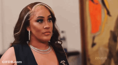 Woman With Necklace And Earrings In Front Of Zeus Ad GIF
