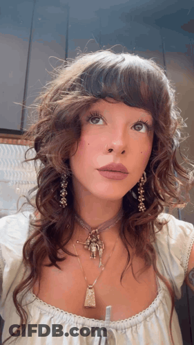Woman With Necklace And Earrings Looking Up GIF