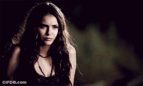Woman With Necklace Looking Down GIF