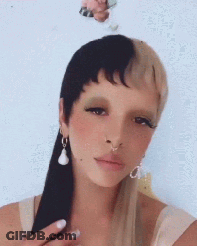 Woman With Nose Ring And Earrings And Half Black Half Blonde Hair GIF
