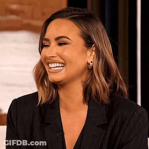 Woman With Nose Ring And Hoop Earrings Smiling GIF