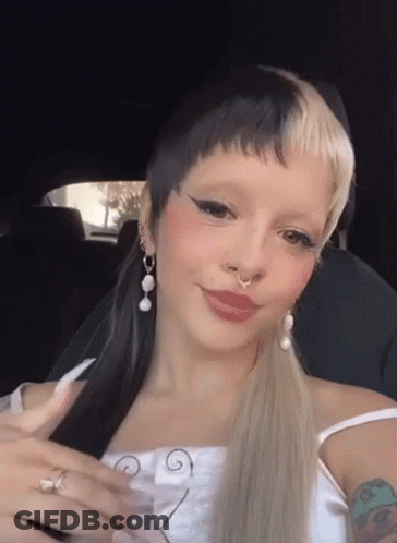 Woman With Nose Ring And Ponytail In Car GIF