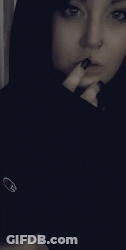 Woman With Nose Ring, Black Nails, Black Nike Shirt GIF
