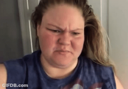 Woman With Nose Ring Making Funny Face In Blue Shirt GIF