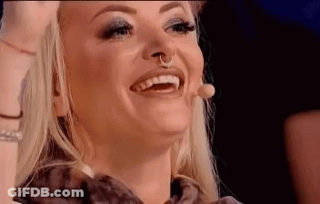 Woman With Nose Ring Smiling And Laughing At Microphone GIF