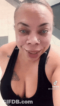 Woman With Nose Ring Smiling In Black Tank Top GIF