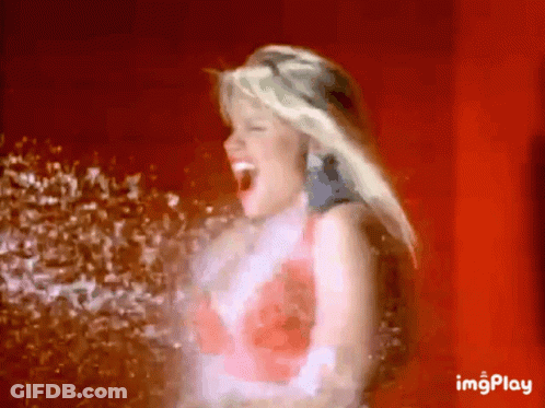 Woman With Open Mouth Being Sprayed GIF
