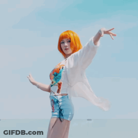 Woman With Orange Hair In White Shirt And Shorts GIF
