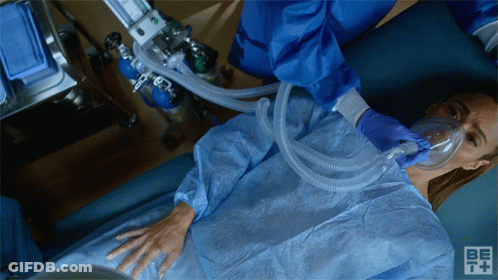 Woman With Oxygen Mask In Hospital Bed GIF