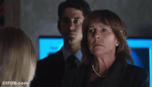 Woman With Pearl Necklace In Front Of Man GIF
