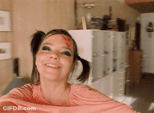 Woman With Pigtails Bloody Face Smiling GIF