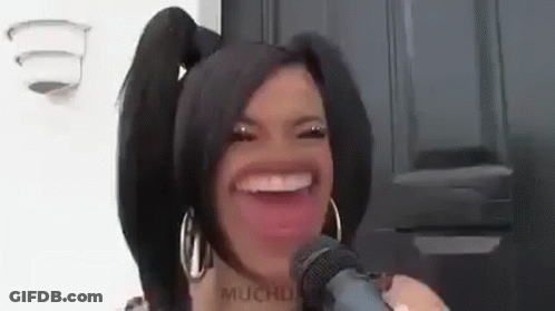 Woman With Pigtails Making Funny Face Holding Microphone GIF
