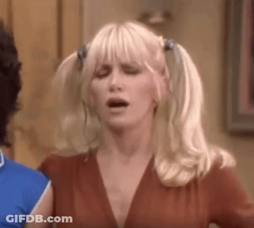 Woman With Pigtails Making Funny Face Next To Man GIF