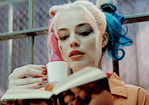 Woman With Pink And Blue Hair Reading Book Drinking Cup GIF