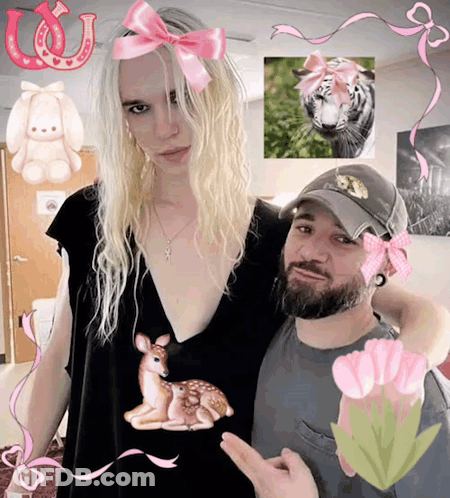Woman With Pink Bow Next To Bearded Man GIF