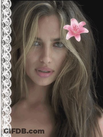 Woman With Pink Flower In Hair GIF