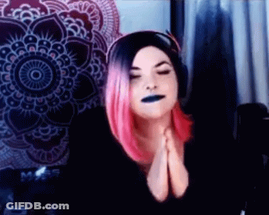 Woman With Pink Hair And Black Lipstick Praying GIF
