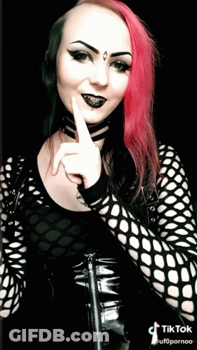 Woman With Pink Hair And Black Makeup In Black Top GIF