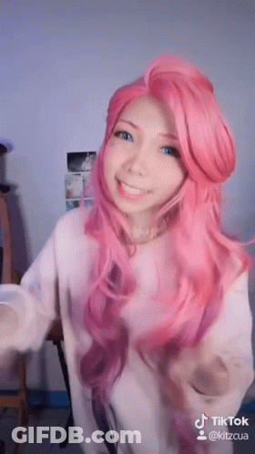 Woman With Pink Hair And Blue Eyes In White Shirt GIF