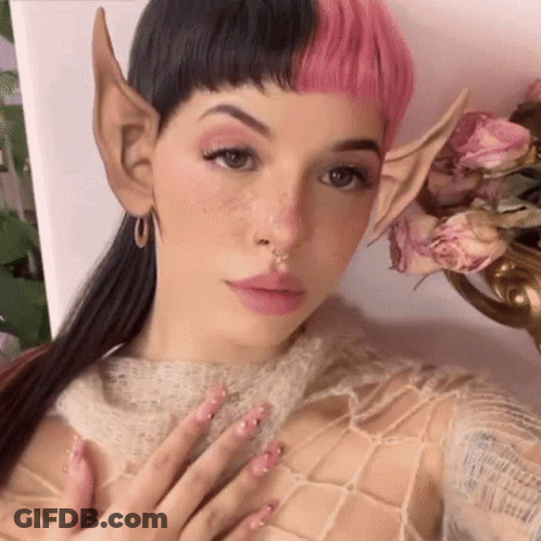Woman With Pink Hair And Elf Ears Selfie Flowers GIF