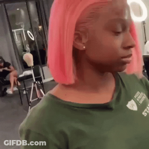 Woman With Pink Hair And Green Shirt Looking At Camera GIF