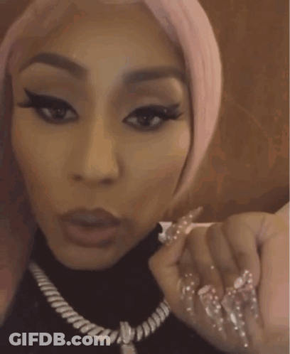 Woman With Pink Hair And Long Nails In Black Turtleneck GIF