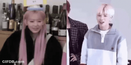 Woman With Pink Hair And Man With White Hair Standing Together GIF
