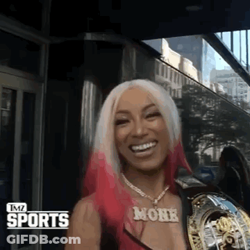 Woman With Pink Hair And Monk Necklace Smiling GIF