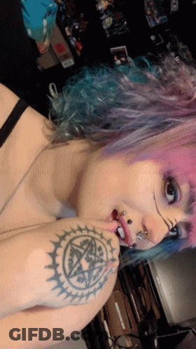 Woman With Pink Hair And Pentagram Tattoo GIF
