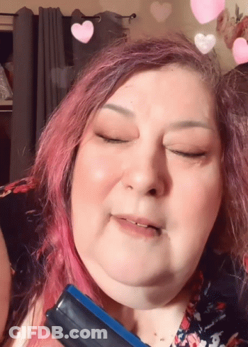 Woman With Pink Hair Holding Blue Brush GIF