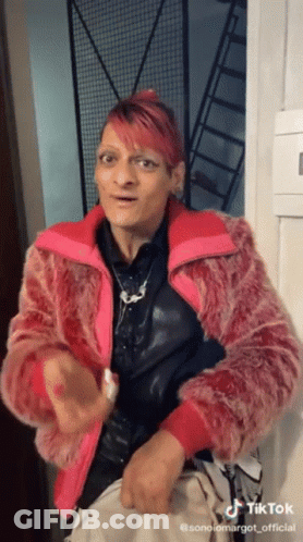 Woman With Pink Hair In Pink Fur Jacket GIF