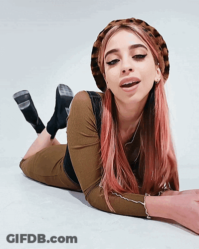 Woman With Pink Hair Laying On Floor Wearing Hat GIF