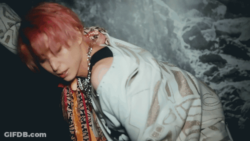 Woman With Pink Hair Laying On Stomach GIF