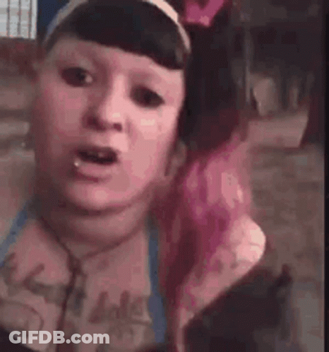 Woman With Pink Hair Making Funny Face Wearing Headphones And Headband GIF