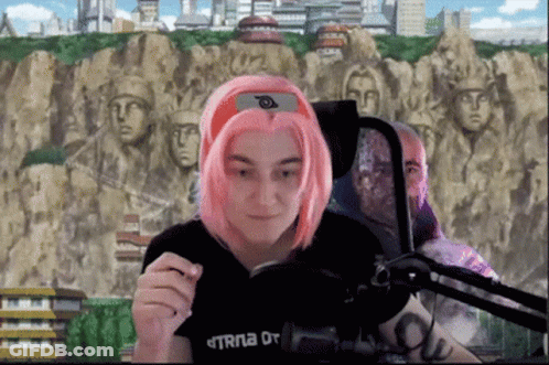 Woman With Pink Hair Sitting At Microphone In Black TRNA Shirt GIF