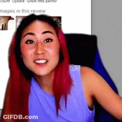 Woman With Pink Hair Sitting In Chair GIF