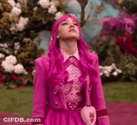 Woman With Pink Hair Sitting In Pink Flowers GIF