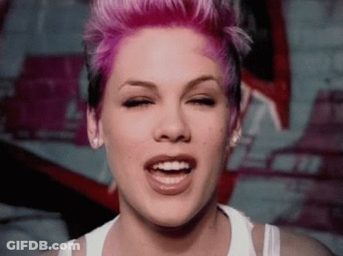Woman With Pink Hair Smiling In White Tank Top GIF