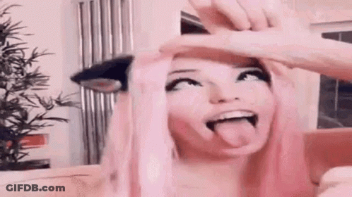 Woman With Pink Hair Sticking Tongue Out GIF