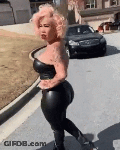 Woman With Pink Hair Walking Next To Black Car GIF