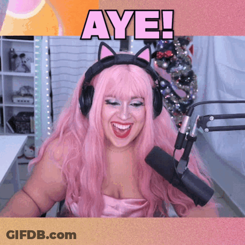 Woman With Pink Hair Wearing Headphones And Microphone Says Aye GIF