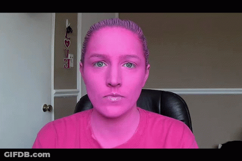 Woman With Pink Paint Sitting At Love Sign GIF
